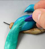 Clay peacock being textured
